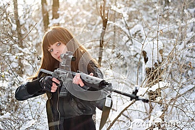Brunette girl aiming a gun Stock Photo