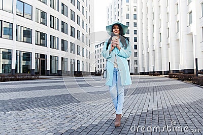 Brunette in hat at city Stock Photo