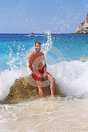 Brunette man at Erimitis beach Paxos island Greece Stock Photo