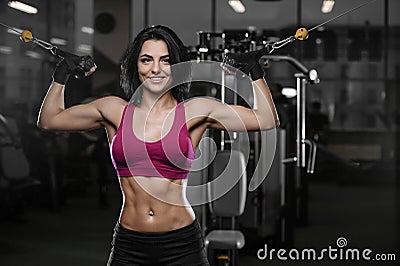 Brunette athletic young girl working out in gym Stock Photo