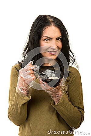 Woman applying hair dye by herself Stock Photo