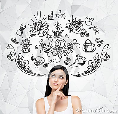 Brunette woman is dreaming about sopping. Shopping icons are flying in the air. Stock Photo