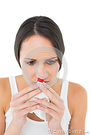 Brunette woman having a nose bleed Stock Photo