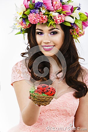brunette woman offers colorful easter eggs Stock Photo