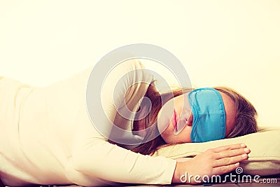 Brunette woman sleeping in blue eye sleep mask Stock Photo