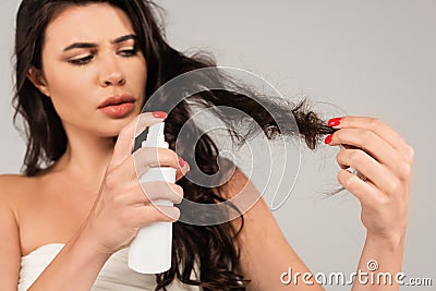 brunette woman spraying treatment product on Stock Photo