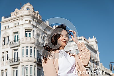 brunette woman standing on windy street Stock Photo