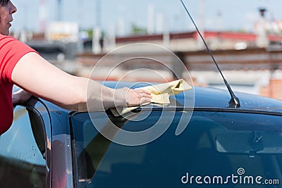 Brunette woman washes her car Stock Photo