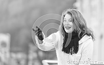 Attractive lady in white knitted coat and scurf. woman exited welcome on street. Stock Photo