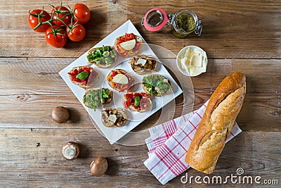 Bruschetta with beans and arugula, mushrooms, goat cheese Stock Photo