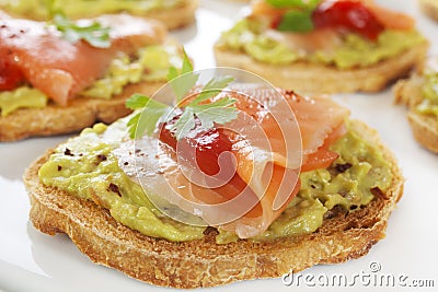 Bruschetta or Crostini with Guacamole, Smoked Salmon and Fire R Stock Photo