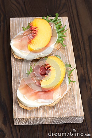 Bruschetta with prosciutto and peaches Stock Photo