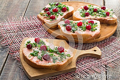 Bruschetta with salmon butter, capelin caviar, cranberry and her Stock Photo