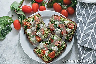 Bruschetta toast with guacamole and tomatoes Stock Photo