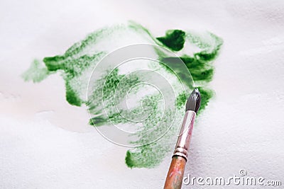 Brush in hands. Artist creating watercolor painting Stock Photo