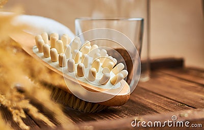 Brush massage counter, washcloth for shower with double nozzles with bunch of dried straw and natural coffee scrub in glass, towel Stock Photo