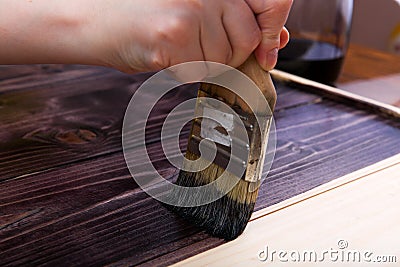 Brush with paint close-up on a light background. Hand craft. Stock Photo