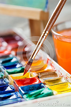 Brush for painting closeup and set of watercolor paints. Stock Photo