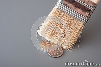 Brush for painting sweep metal money on a gray surface Stock Photo