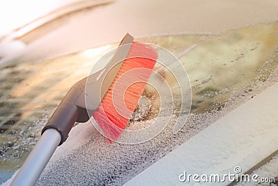 Brush snow from the car window in winter after a snowfall Stock Photo