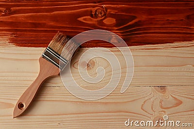 Brush and wooden surface dyed with mordant Stock Photo