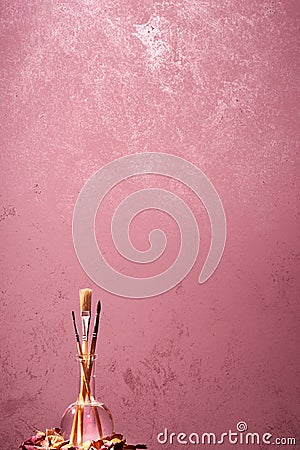 Brushes on a painted wall background. Stock Photo