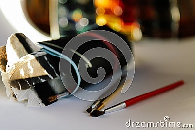 Brushes, paints and drawing paper on a white background, conceptual for artists and designers Stock Photo