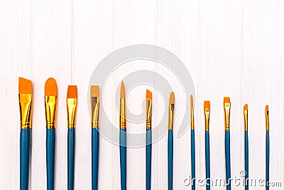 Brushes on white wooden background Stock Photo