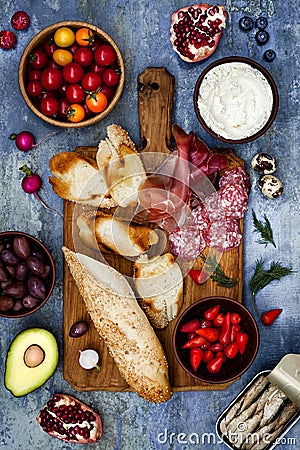 Brushetta or authentic traditional spanish tapas set for lunch table. Sharing antipasti on party picnic time on blue background Stock Photo