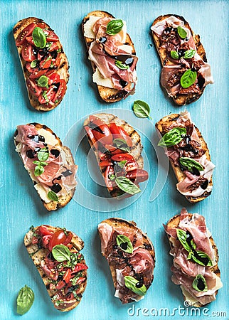 Brushetta set for wine. Variety of small sandwiches on turquoise blue backdrop, top view Stock Photo