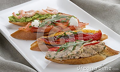 Brushetta snacks for wine. Variety of small sandwiches on a textile background Stock Photo