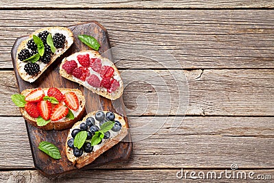 Brushetta or traditional spanish tapas with various berries. Appetizers italian antipasti snacks set. Top view and flat lay with Stock Photo