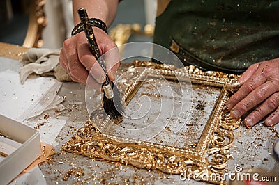 Brushing a frame during the gilding process tecnique Stock Photo