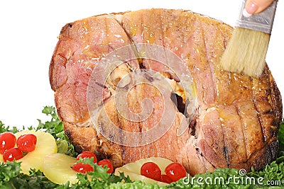 Brushing ham with glaze Stock Photo