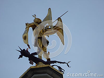 BRUSSELS - AUGUST 5, 2017: Saint George slaying the dragon statue on the city hall building tower Editorial Stock Photo