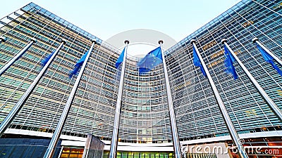 European Union EU flags waving in front of the Berlaymont building, headquarters of the European Commission in Brussels. Editorial Stock Photo