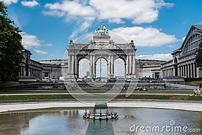 Brussels - Belgium - The cinquantenaire city park with a fountain, colorful flowers and the symbolic arcades in the background Editorial Stock Photo
