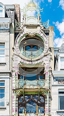 Brussels, Belgium - Typical art nouveau facade with shaped metal ornaments, round windows, arches Editorial Stock Photo