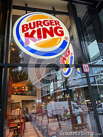 Brussels, Brabant, Belgium 08 26 2022 , Closeup on the Burger King logo and refflection in the glass of the shop Editorial Stock Photo