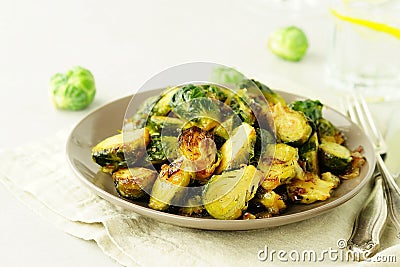 Brussels sprouts roasted fried with onions on a plate top view. Stock Photo