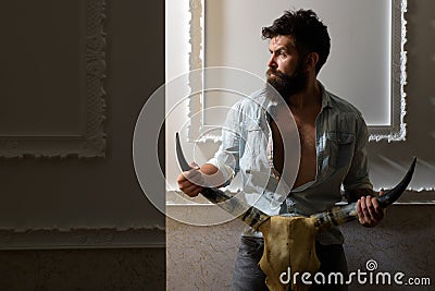 Brutal bearded man with animal skull. serious hipster with beard. male barber. barbershop salon. brutal caucasian Stock Photo