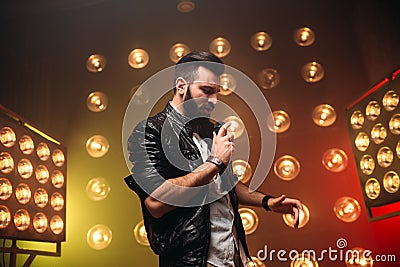 Brutal bearded singer with microphone sing a song Stock Photo