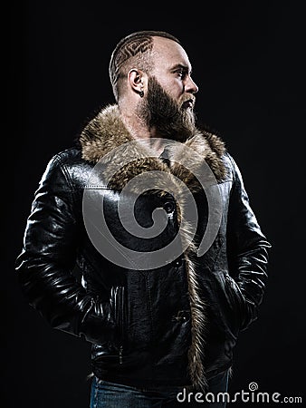 Brutal handsome unshaven man with long beard and moustache in bl Stock Photo