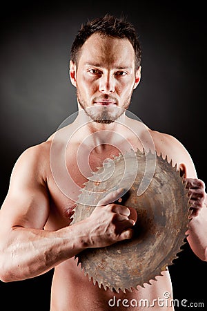 Brutal man holding a circular blade Stock Photo