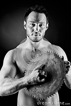 Brutal man holding a circular blade Stock Photo