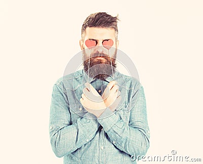 Brutal man in love. Blind from love. Hipster with paper red hearts and serious face. Bearded man holds symbols of Stock Photo