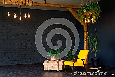 Brutal modern interior in a dark color with a yellow leather chair. Loft style living room Stock Photo