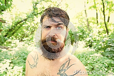 Brutal and rugged. Hairy hipster wearing long beard and mustache in brutal style. Bearded man with brutal look on summer Stock Photo