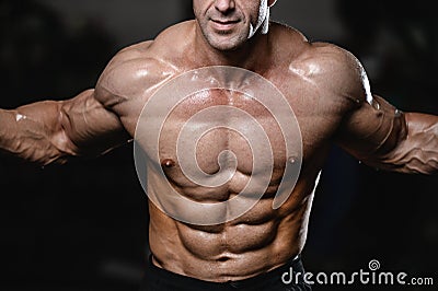 Brutal strong bodybuilder man pumping up muscles and train gym Stock Photo