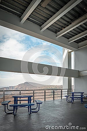 Brutalist concrete architecture, large space overlooking a ravine, blue dining benches. Beam framing the landscape Stock Photo